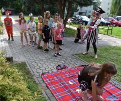 Dzieci podczas zabawy przed budynkiem biblioteki