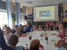 Dzieci siedzą przy stoliku podczas zajęć