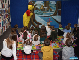 Aktor w przebraniu Kubusia stoi a dzieci stoją