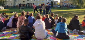 troje dzieci stoi naśrodku w kaskah ochronnych
